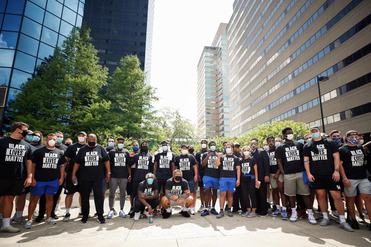 University of Kentucky football players and coaches organized to march in support of the Black Lives Matter movement in downtown Lexington on Friday.