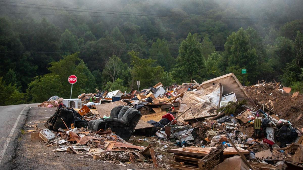 Toys, furniture, household goods and other items damaged by flood waters are piled in a vacant lot near Hindman in Knott County, Ky., on Thursday, Aug. 4, 2022.