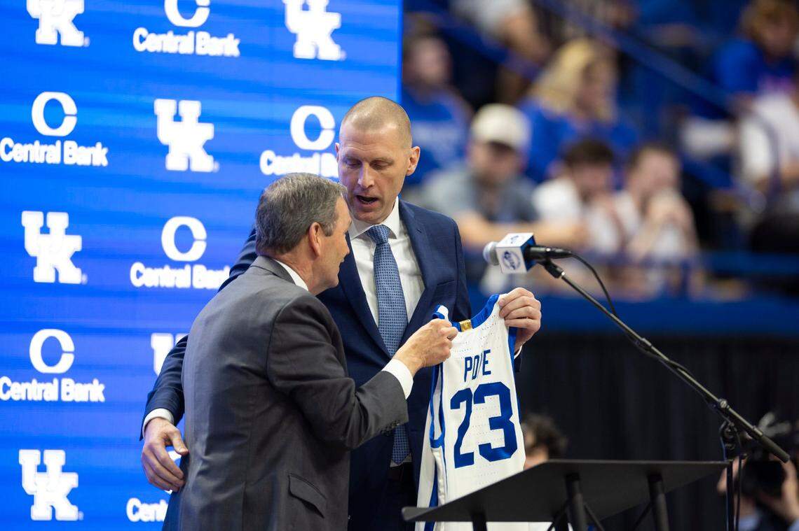 UK athletic director Mitch Barnhart gives Mark Pope a Kentucky basketball jersey at Pope’s introductory press conference in April 2024 at Rupp Arena. Barnhart will retire as UK’s AD in June. 