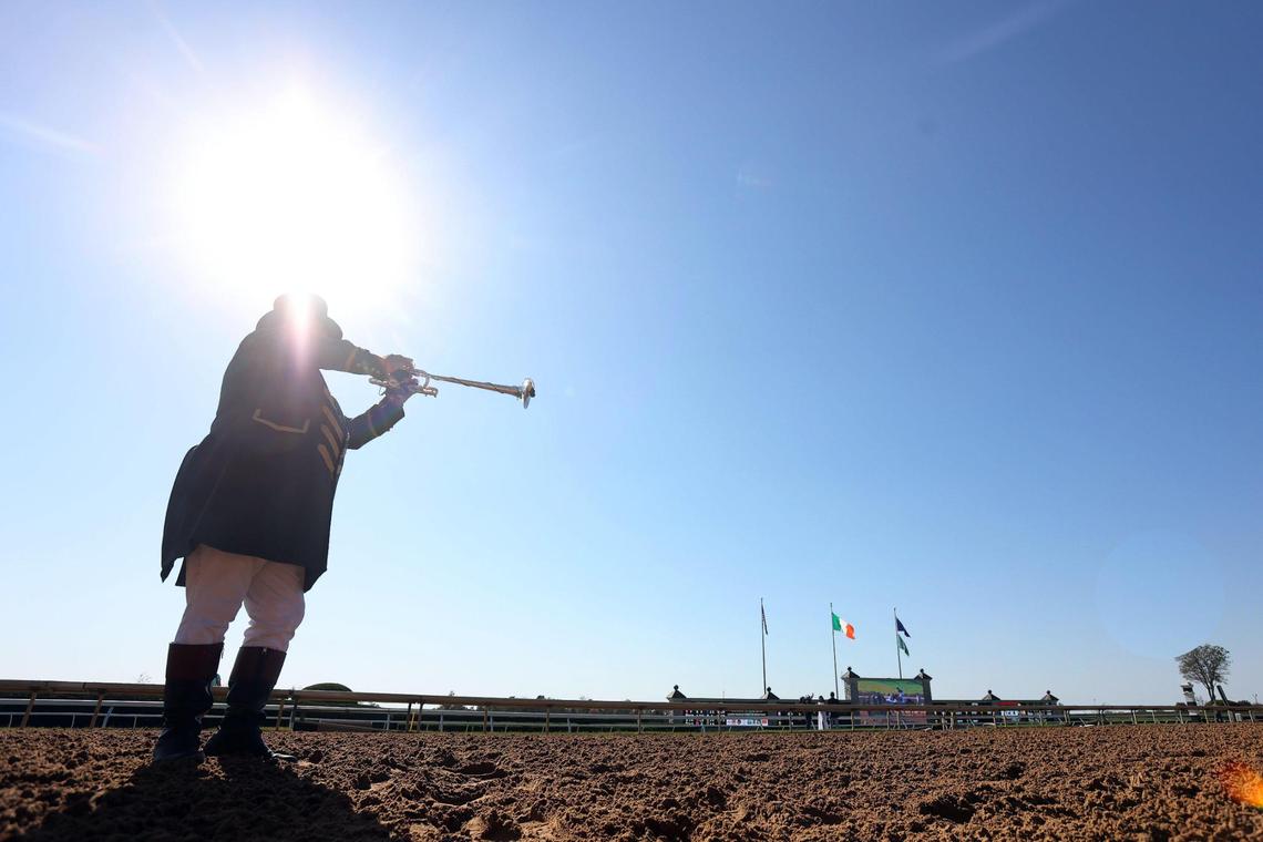 Bugler Steve Buttleman plays the call to the post before a race at Keeneland last fall.
