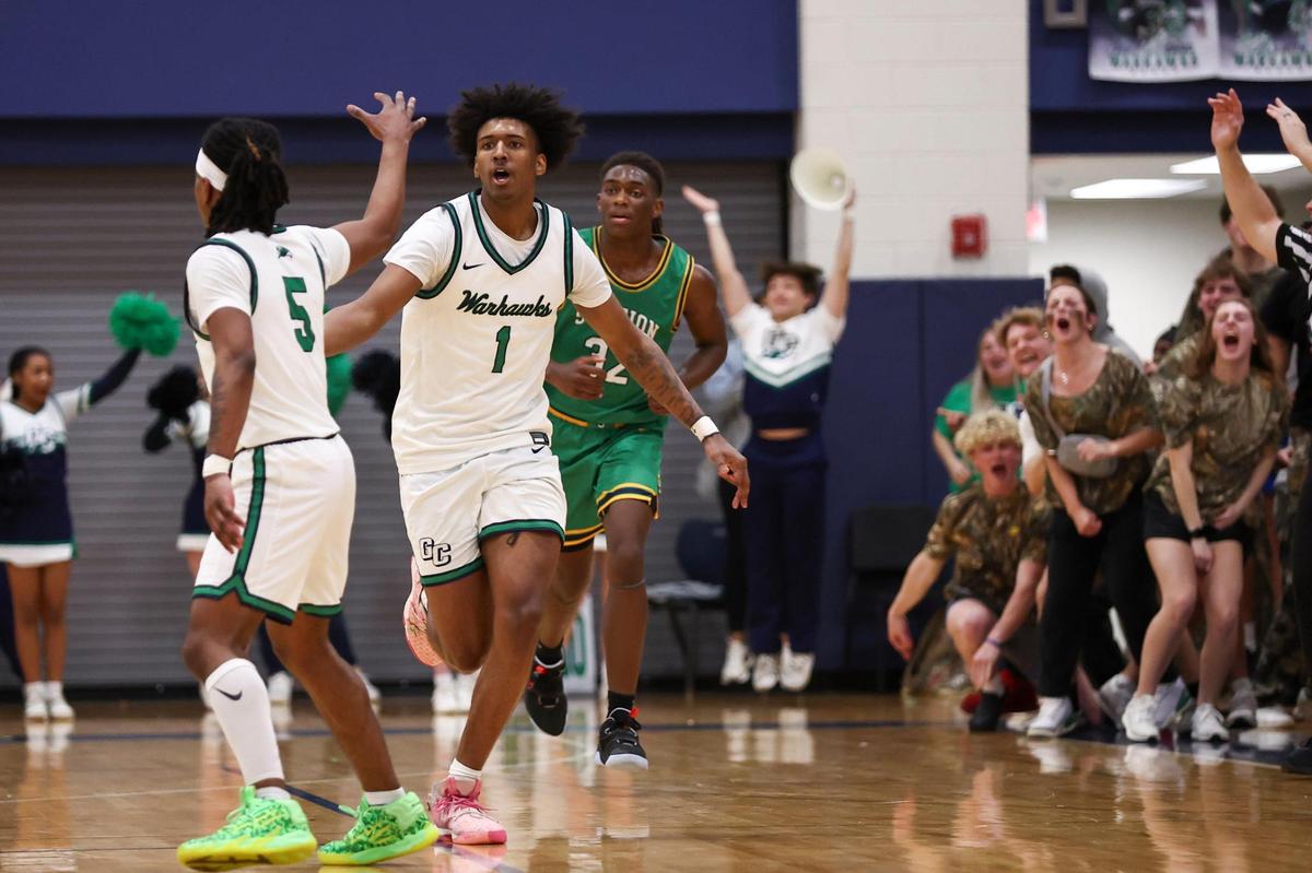 Great Crossing’s Vince Dawson III (1) celebrates making a 3-pointer against Bryan Station during the 11th Region Tournament quarterfinals at Great Crossing High School on Tuesday. Dawson led the Warhawks with 22 points.