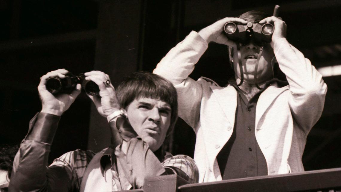 Cincinnati Reds third baseman Pete Rose, left, grimaces while watching the races at Keeneland on October 13, 1976. The Reds had won the National League playoff series against Philadelphia the day before.