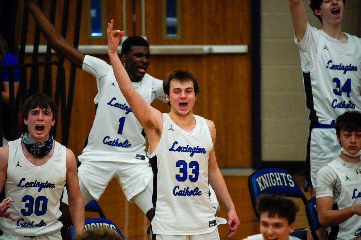 Lexington Catholic’s Ben Johnson (33) and his teammates celebrated during their 83-51 victory against North Laurel on Saturday.