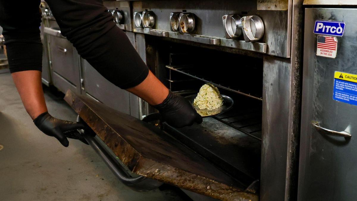 A Jumbo Lump Crab Cake appetizer is placed into an oven to bake, Tuesday, June 10, 2025 at Tony’s of Lexington in downtown Lexington, Ky. Before going into a 350 degree oven for about 15 minutes, the crab cake is covered in clarified butter.