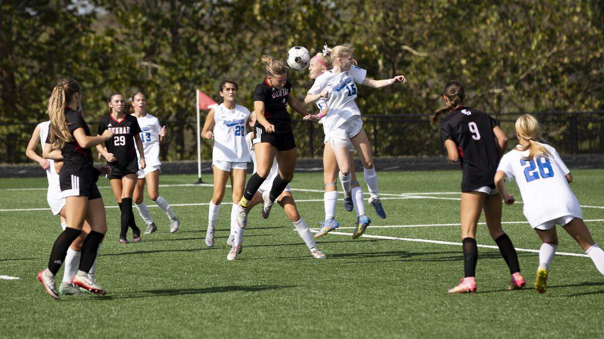 Paul Laurence Dunbar’s Kennedy Morgan (4) and Lexington Catholic’s Harper Ward (back) and Lily Knopp (15) jumped for corner kick ball in front of the Knights’ goal during the 11th Region girls soccer tournament championship game at Scott County High School in Georgetown on Saturday.