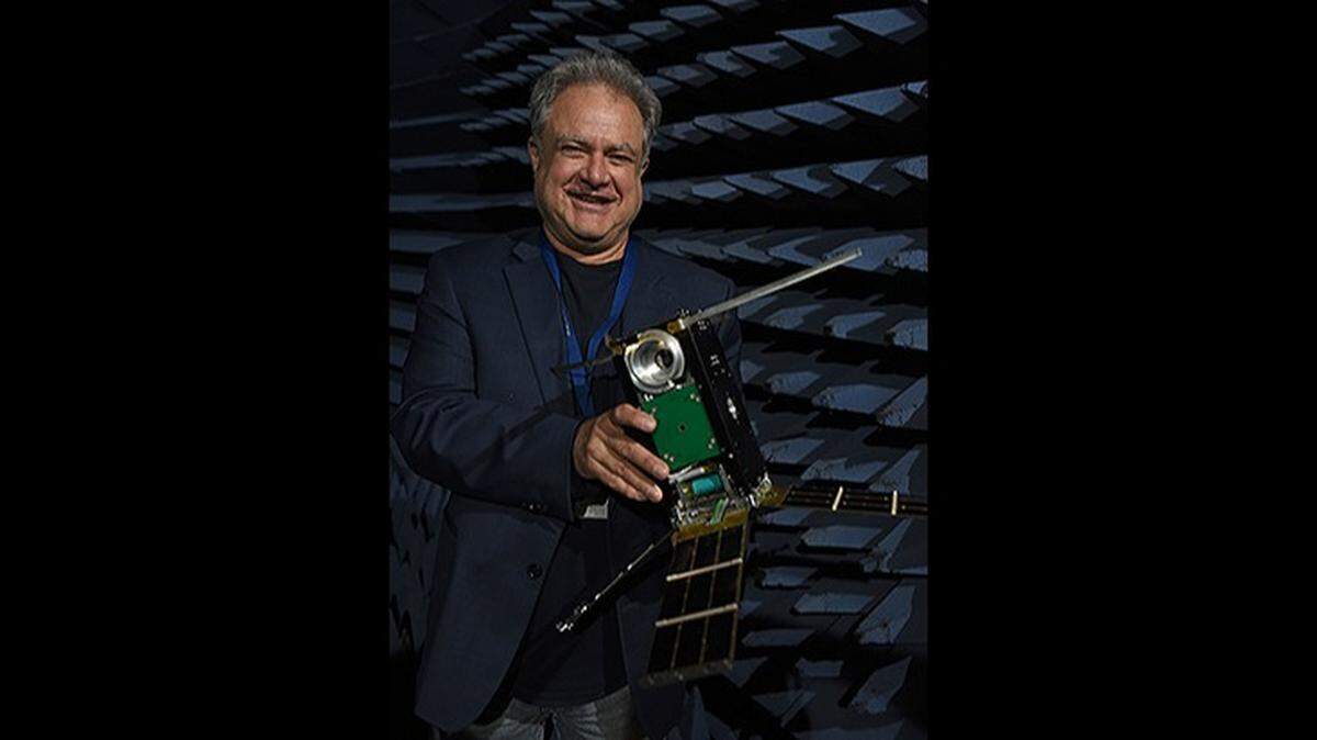 Dr. Ben Malphrus, executive director of MSU’s Space Science Center, holds a model of the Lunar IceCube that will be launched on Artemis I.