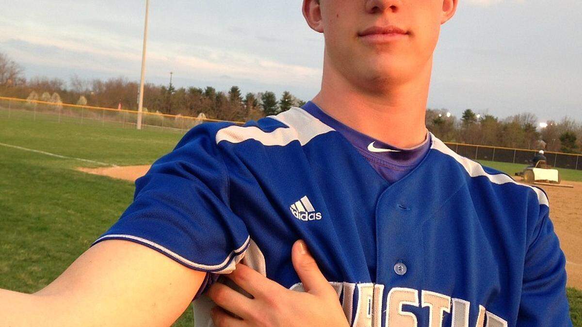 Lincoln Henzman of Lexington Christian showed off his scar from Tommy John surgery, performed a year ago.