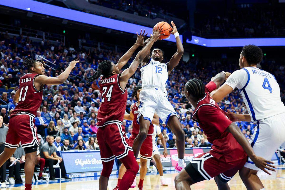 Kentucky guard Antonio Reeves (12) shoots the ball against New Mexico State forward Jonathan Kanyanga (24) during the season opener at Rupp Arena.