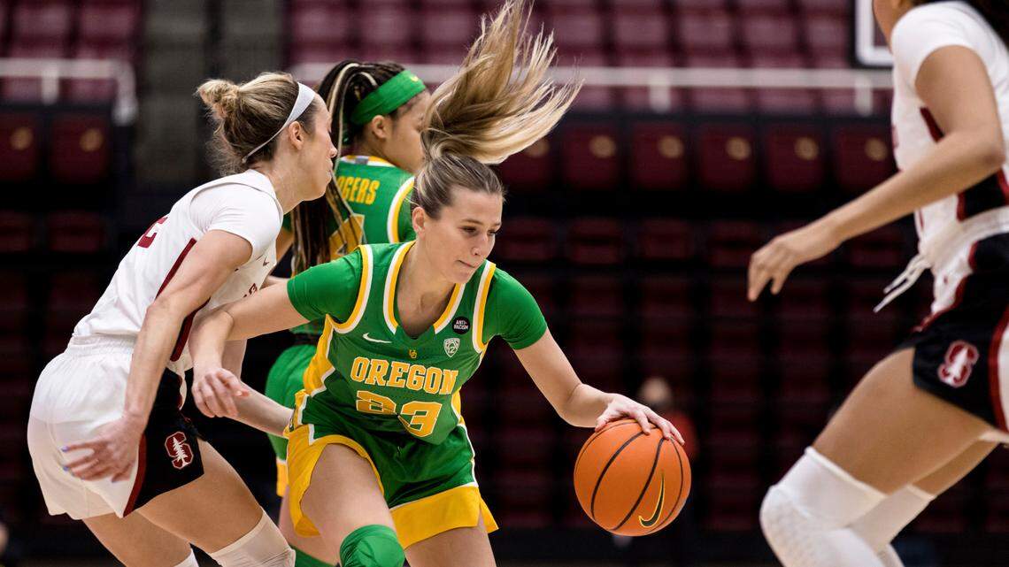 Oregon guard Maddie Scherr (23) dribbles as Stanford guard Lexie Hull, left, defends during the first half of an NCAA college basketball game Friday, Jan. 7, 2022, in Stanford, Calif. (AP Photo/John Hefti) Scherr has transferred from Oregon to Kentucky.