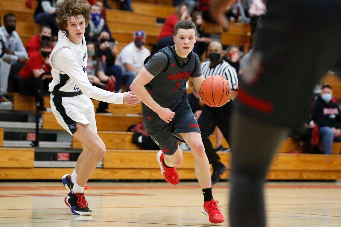 Paul Laurence Dunbar’s Nick Spalding (2) dribbles past Lexington Catholic’s Hudson Sparks (31) during the 43rd District championship at Lafayette on March 19, 2021.