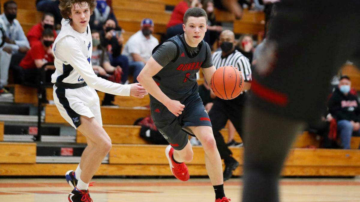 Paul Laurence Dunbar’s Nick Spalding (2) dribbles past Lexington Catholic’s Hudson Sparks (31) during the 43rd District championship at Lafayette High School in Lexington, Ky., Friday, March 19, 2021.