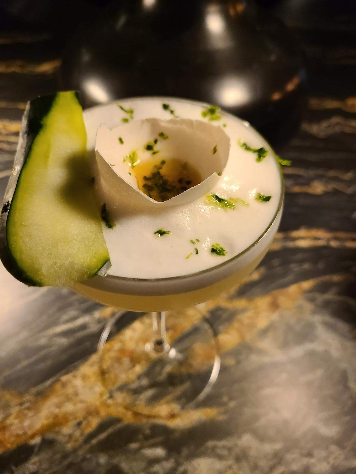 The Glass House cocktail from Trifecta Glass Art Lounge is a cucumber-flavored vodka, garnished with celery bitters and a half broken eggshell to make it look like egg yolk.
