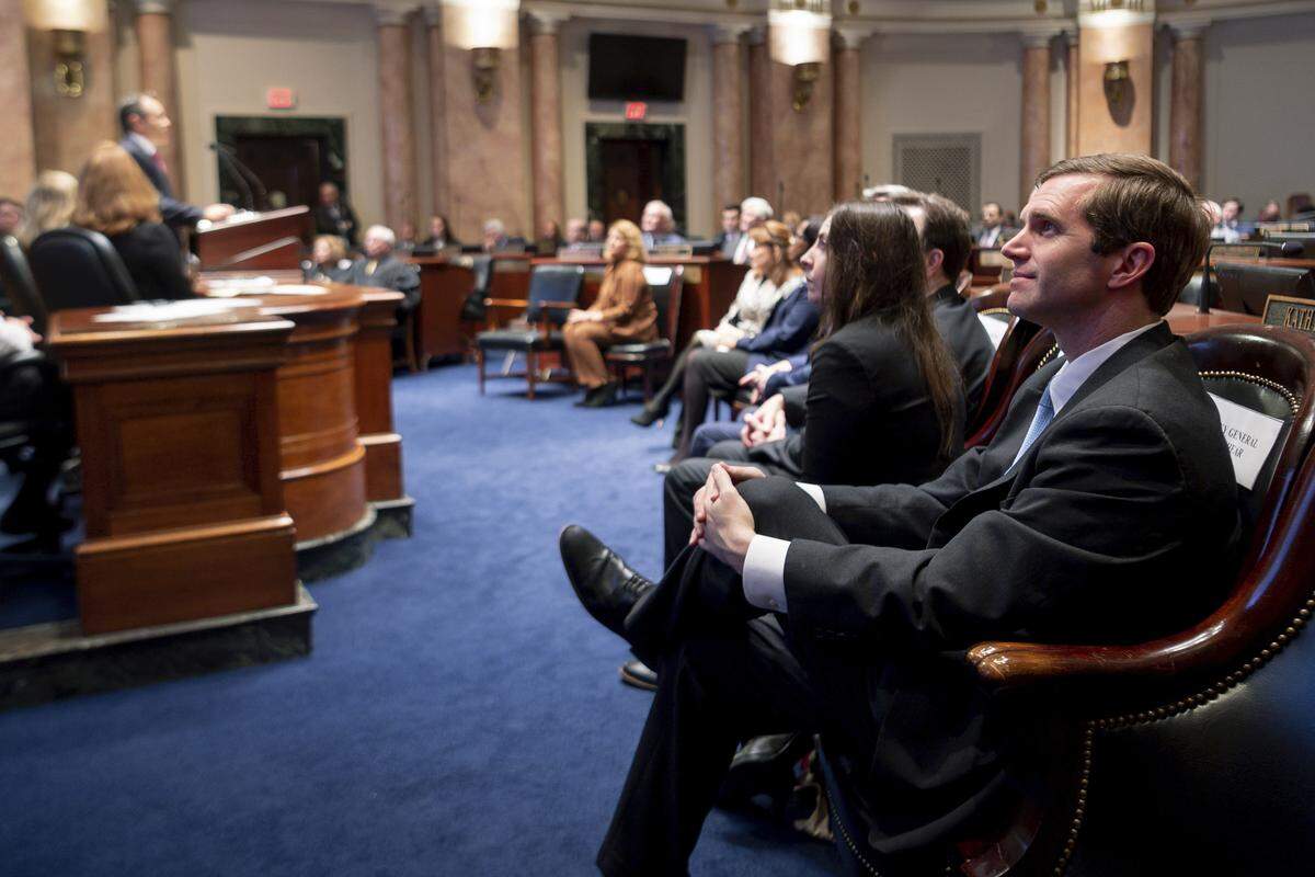 Kentucky Attorney General Andy Beshear, right, looks on as Gov. Matt Bevin delivers the State of the Commonwealth address to a joint session of the state legislature at the state Capitol in Frankfort, Ky, Thursday, Feb. 7, 2019. (AP Photo/Bryan Woolston)