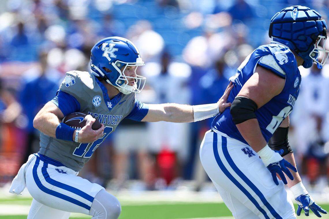 Kentucky quarterback and Georgia transfer Brock Vandagriff, left, runs the ball during the Blue-White Game at Kroger Field on April 13.