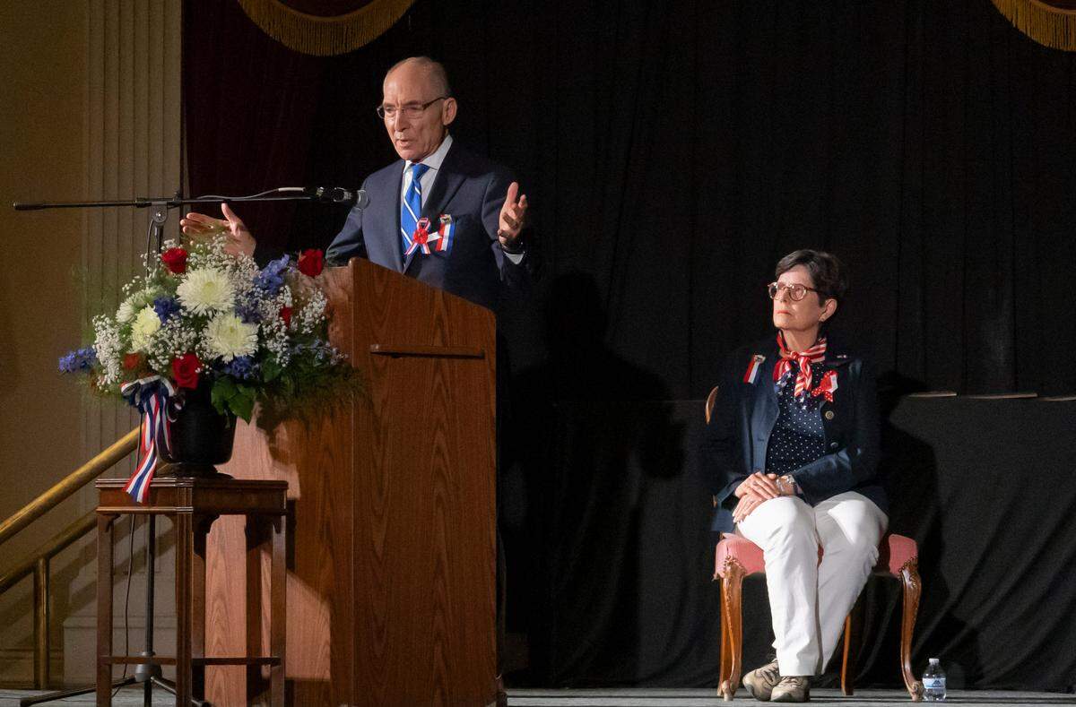 Lexington Mayor Linda Gorton (right) listens University of Kentucky President Eli Capilouto speak the soldiers who fought in World War II at a D-Day 80th anniversary memorial event Thursday night at the Kentucky Theatre. “Let us continue to remember and celebrate their legacy ensuring their sacrifice was never forgotten,” Capilouto said.