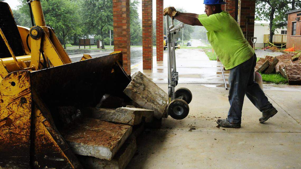 At Mary Todd Elementary, construction worker Danny Land loaded concrete slabs onto a backhoe for removal from the site.