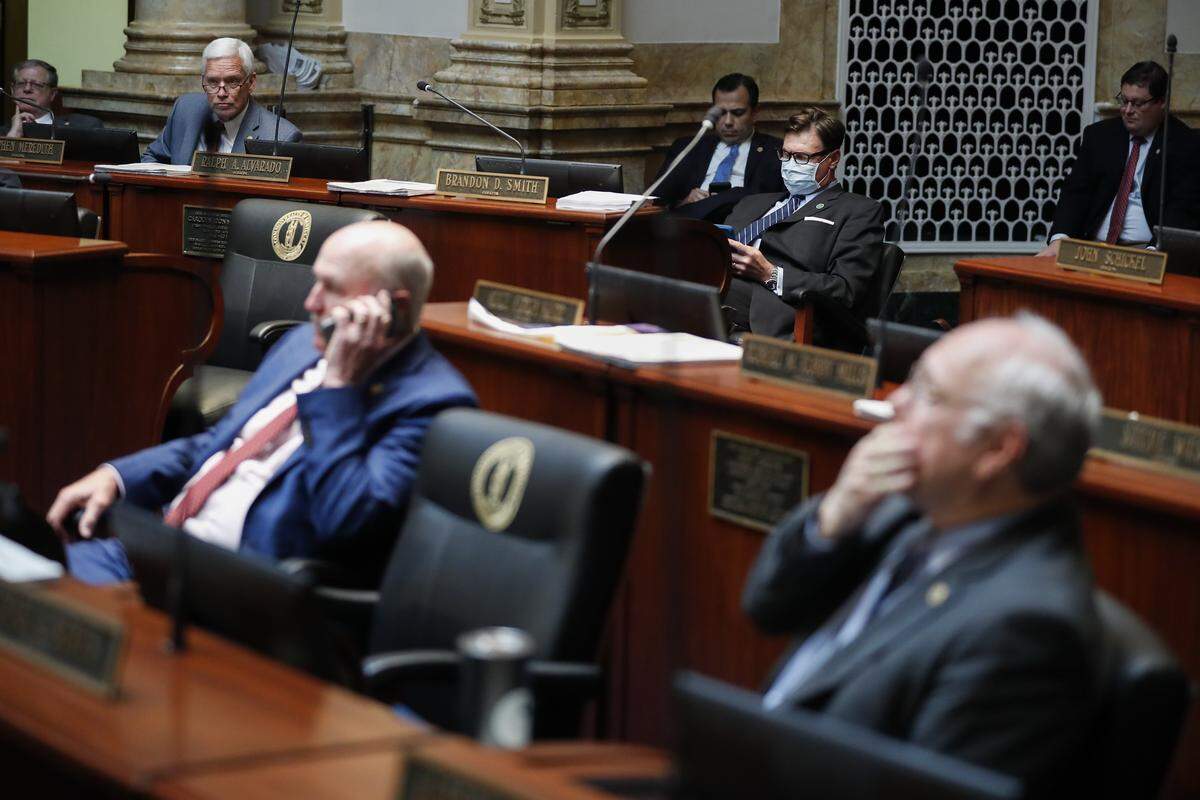 Sen. Brandon Smith, R-Hazard, wears a face mask in an effort to protect himself from COVID-19 during a Kentucky Senate floor session at the state Capitol In Frankfort, Ky., Wednesday, April 1, 2020.