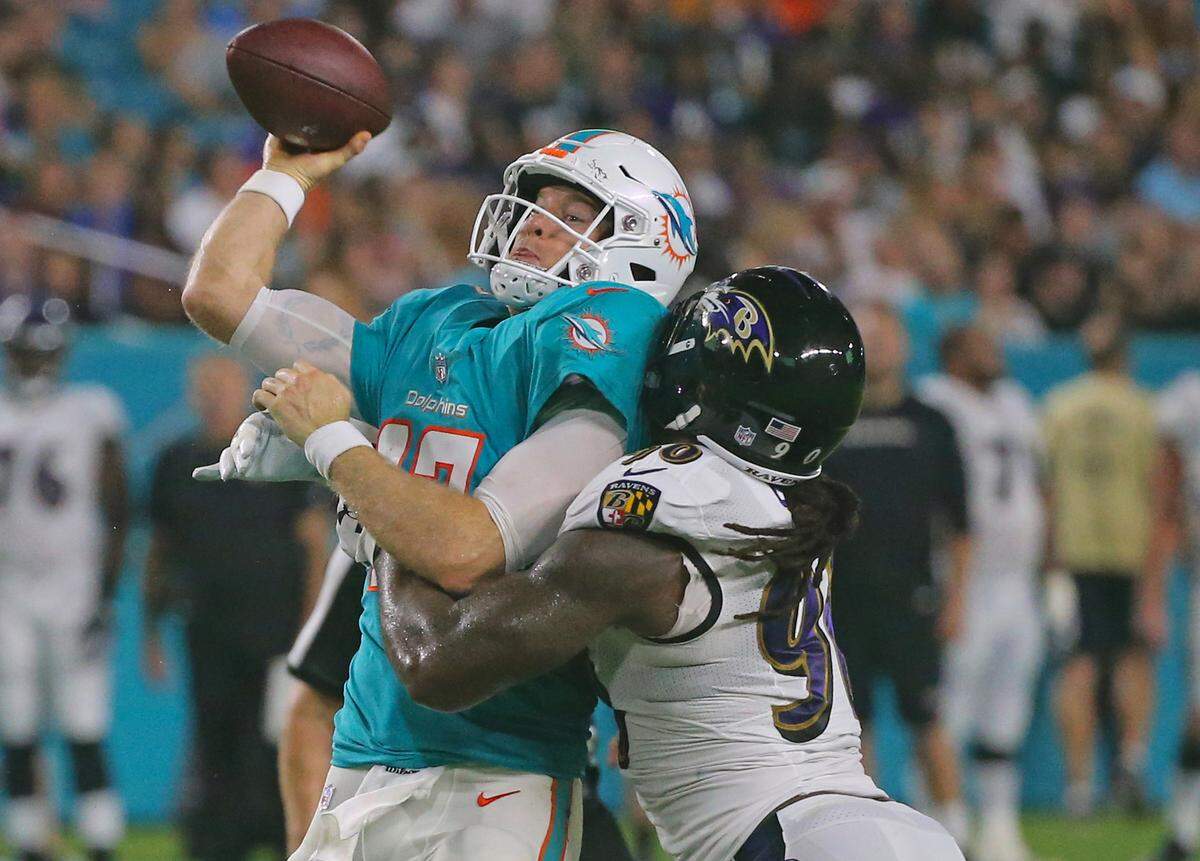 Baltimore Ravens linebacker Za’Darius Smith hit Dolphins quarterback Ryan Tannehill during an exhibition game at Miami last month. Smith recorded 3.5 quarterback sacks last season.