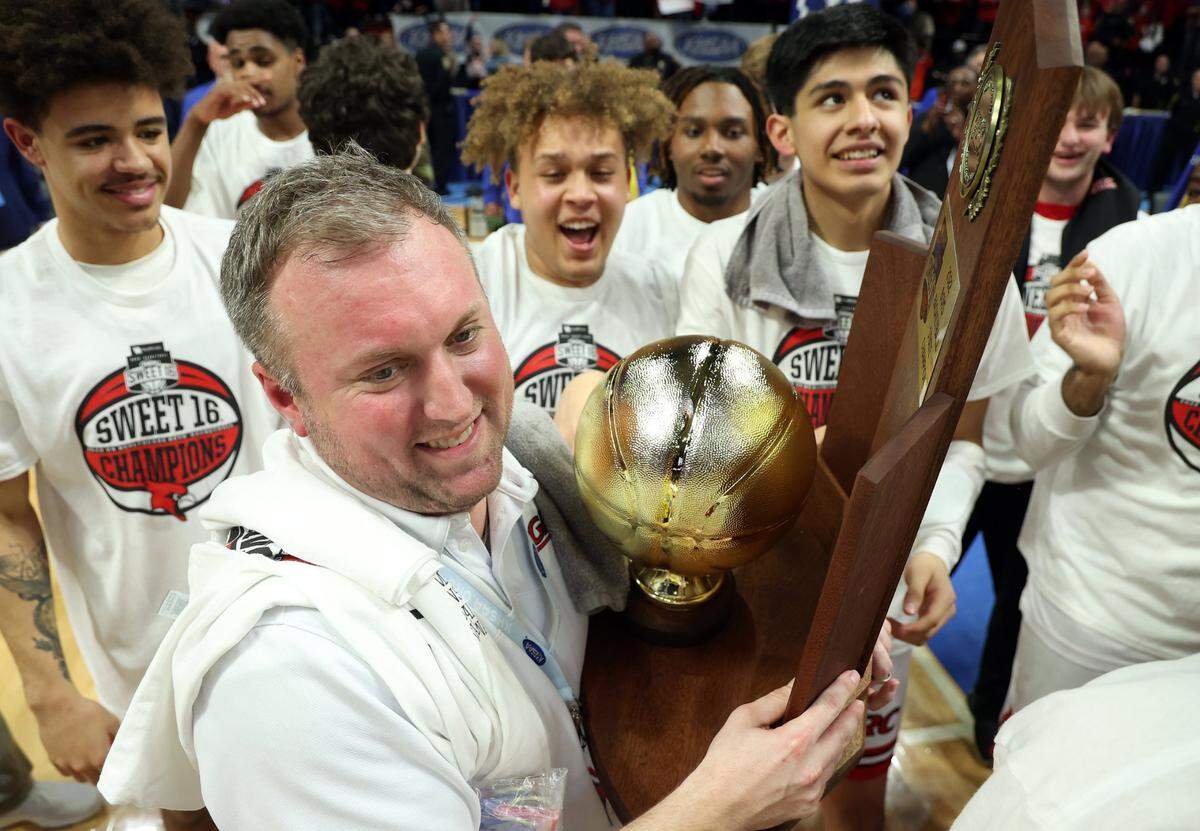 Clark County head coach Joshua Cook holds the trophy after leading his team to Boys’ Sweet 16 championship. “If you ever want to learn life lessons, you’ve got to sacrifice,” Cook said. “And if you sacrifice in the end, you will be rewarded. And that’s why we’re state champions.”