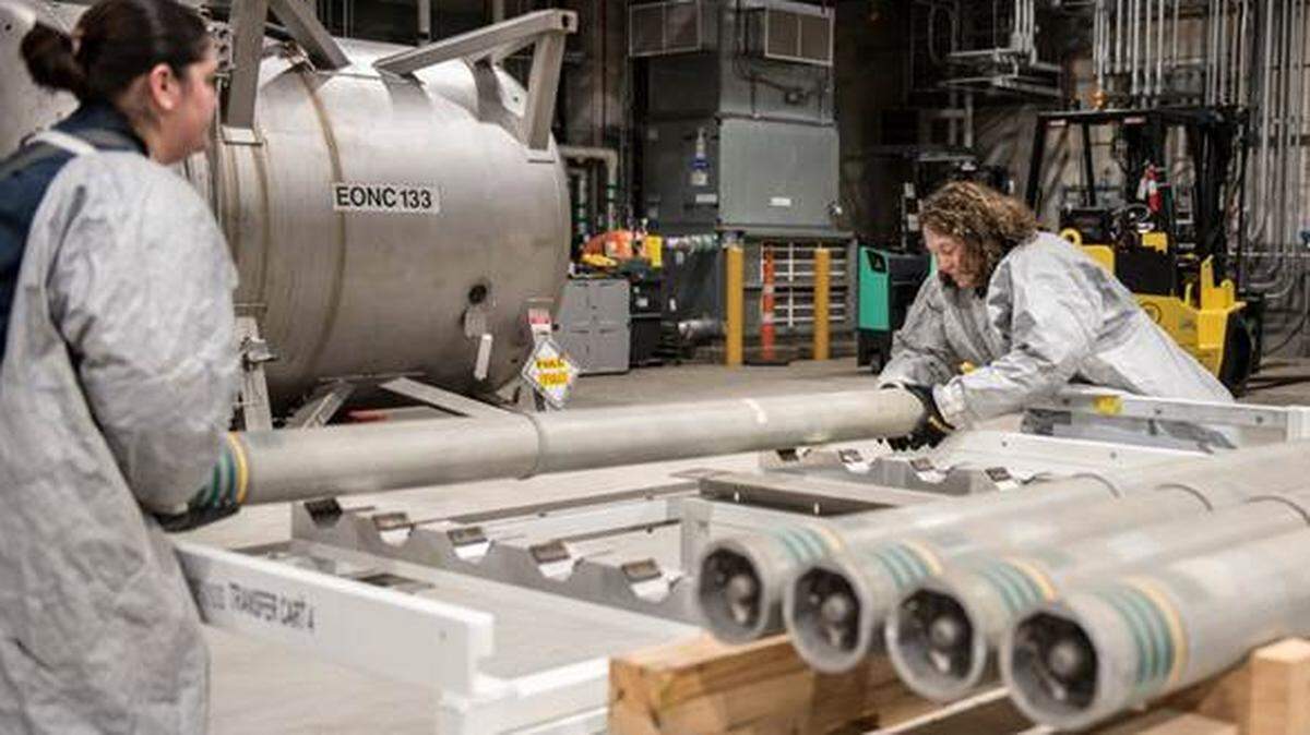 Operators move M55 rockets containing VX nerve agent from a pallet to a transfer cart to begin the destruction process at the Blue Grass Chemical Agent-Destruction Pilot Plant April 15, 2022.