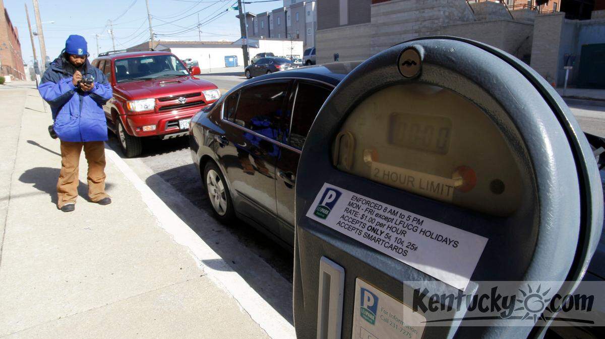 Clarice McDowell, with Lexpark, issued an expired meter parking citation to a car parked on Boliver St. in Lexington Ky., Friday, March 22, 2013. Photo by Charles Bertram | Staff