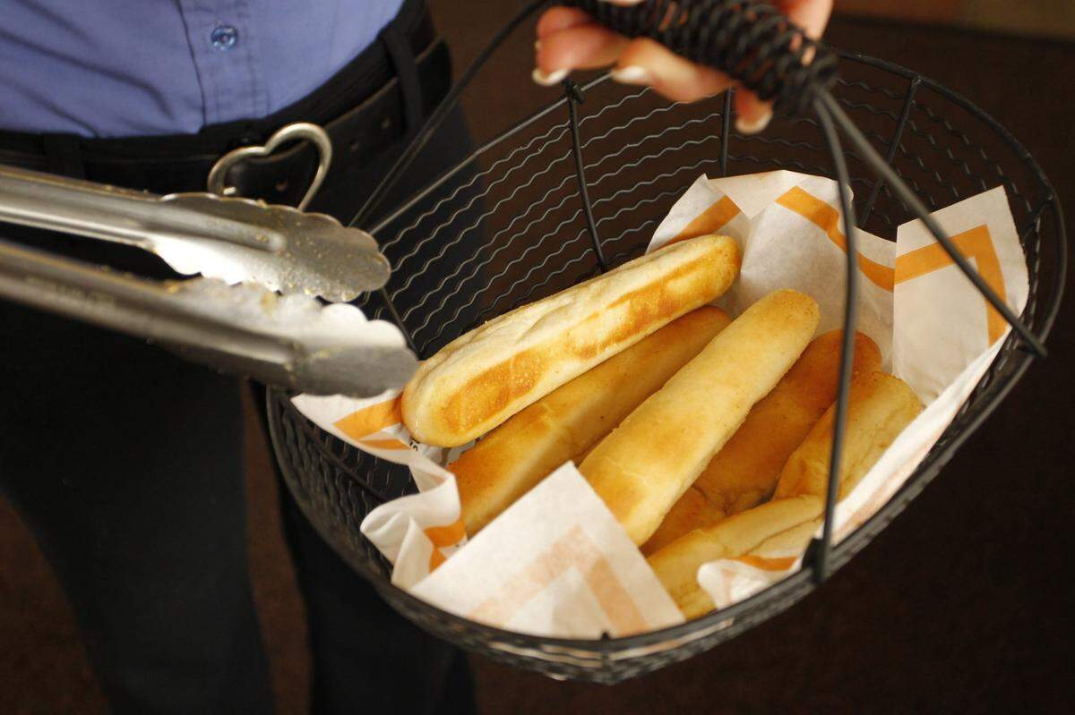 Heather Bussell showed the return of the breadstick basket at Fazoli’s on Winslow St. near the UK campus in Lexington, Ky., on Tuesday March 8, 2011. The Lexington-based chain has begun a turnaround based on a new menu, redecorated restaurants and new services including a breadstick person constantly in the dining room.