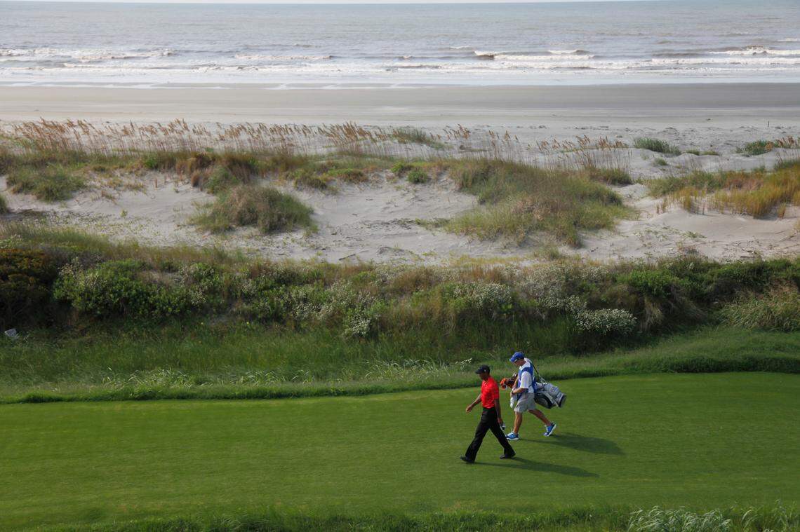 Tiger Woods walks to the 18th green during the weather delayed third round of the PGA Championship golf tournament on the Ocean Course of the Kiawah Island Golf Resort in Kiawah Island, S.C., Sunday, Aug. 12, 2012. (AP Photo/Evan Vucci)
