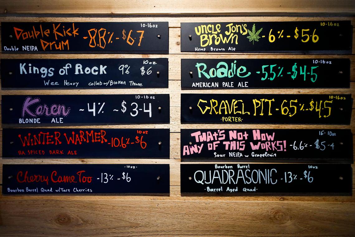 A beer menu hangs on the wall in the tap room at Rock House Brewing. Many beers are an homage to rock music.