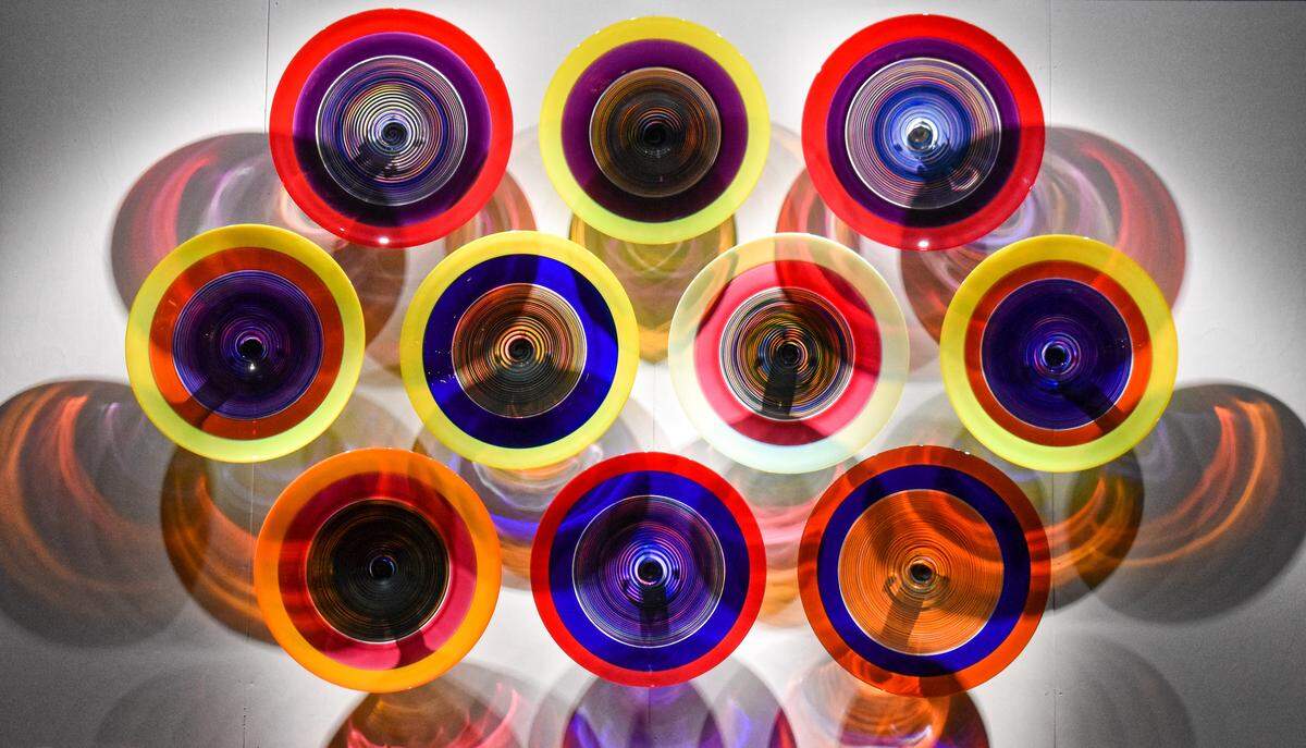 The 10 large platter-like works that make up “Wall of Echoes” feature light passing through them in radiating rings.