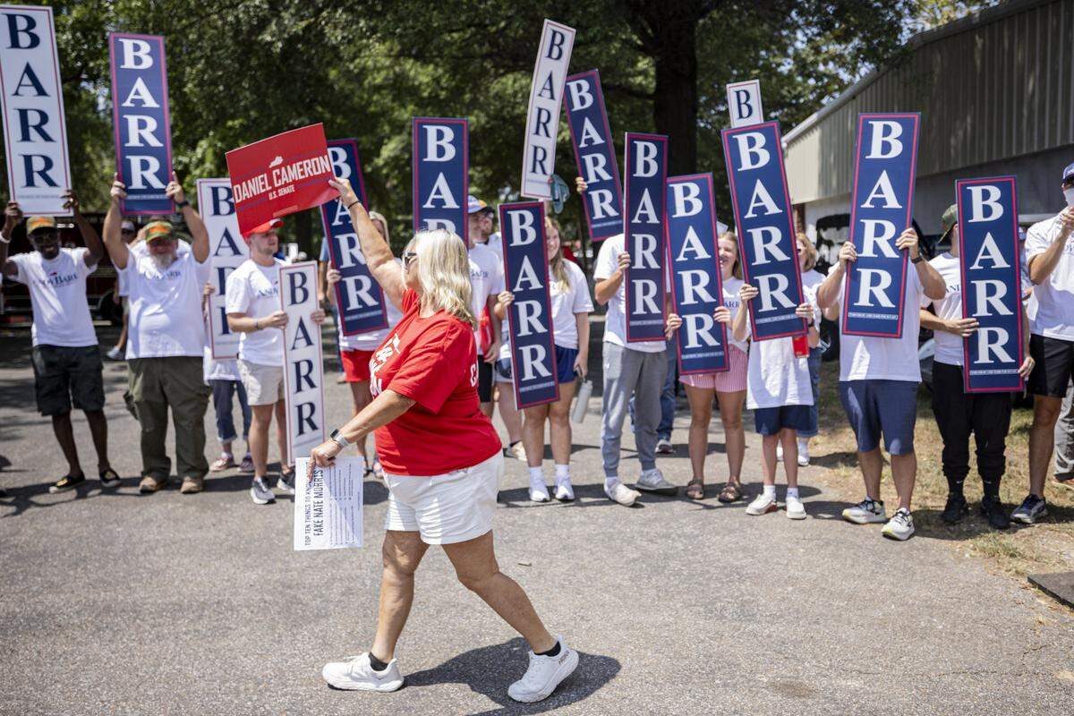 Carolyn Williams, center, walking past Andy Barr supporters while cheering for Daniel Cameron during Fancy Farm Picnic on Saturday, Aug. 2, 2025, at St. Jerome Church in Fancy Farm, Ky.