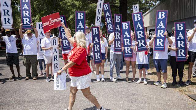 Carolyn Williams, center, walking past Andy Barr supporters while cheering for Daniel Cameron during Fancy Farm Picnic on Saturday, Aug. 2, 2025, at St. Jerome Church in Fancy Farm, Ky.