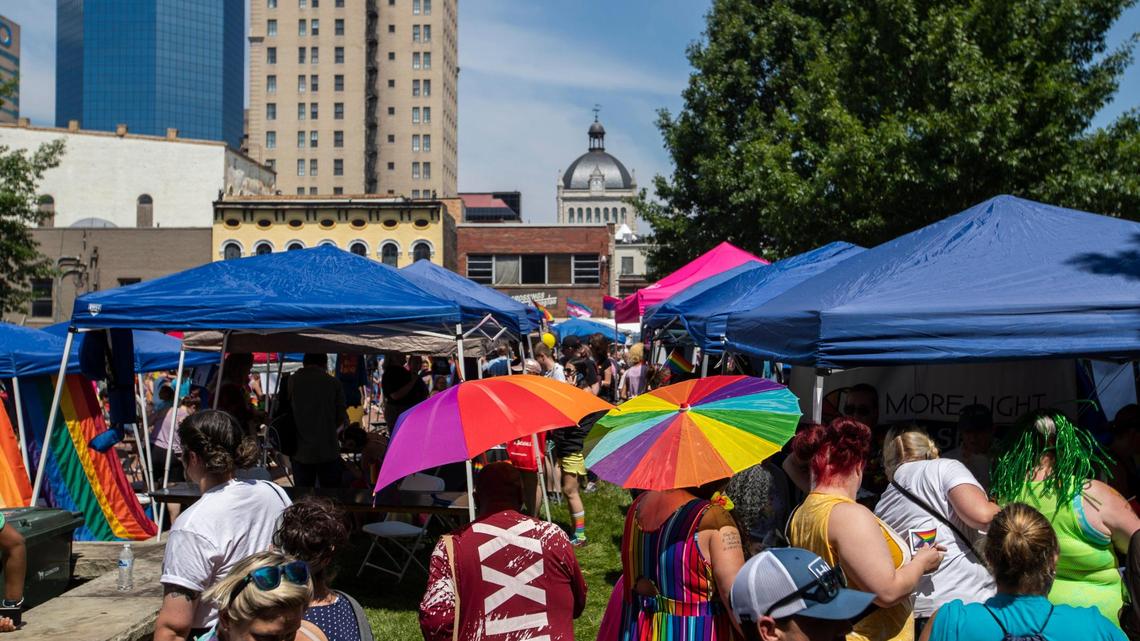 Attendees weave through tents set up during the annual Lexington Pride Festival in front of the Robert Stephens Courthouse in Lexington, Ky., Saturday, June 25, 2022.