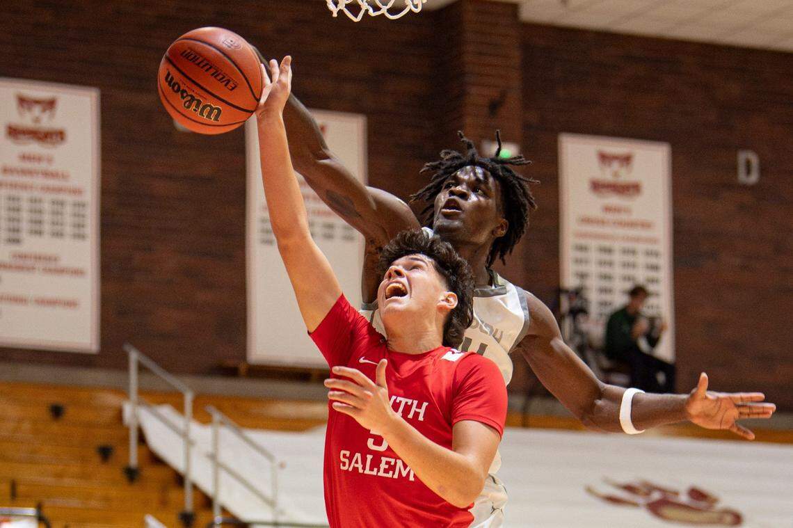 St. Joseph's Tounde Yessoufou (24) blocks South Salem's Jacob Nemecek's (5) shot during the first round of the Capitol City Classic at Willamette University on Saturday, Dec. 16, 2023, in Salem, Ore.