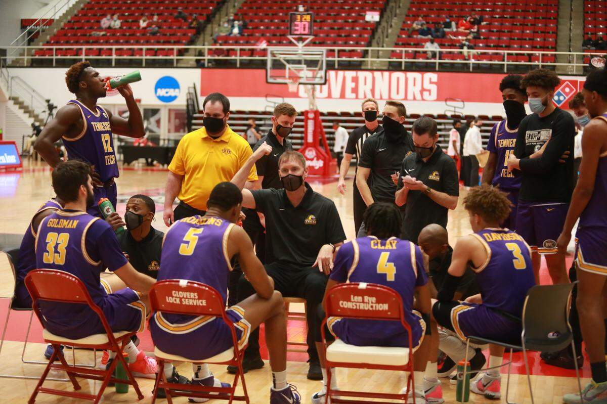 Tennessee Tech Coach John Pelphrey, masked and facing the bench, missed the Golden Eagles’ first four games last season after contracting the coronavirus. “My experience with COVID, it was not good at all,” the former Kentucky forward says.