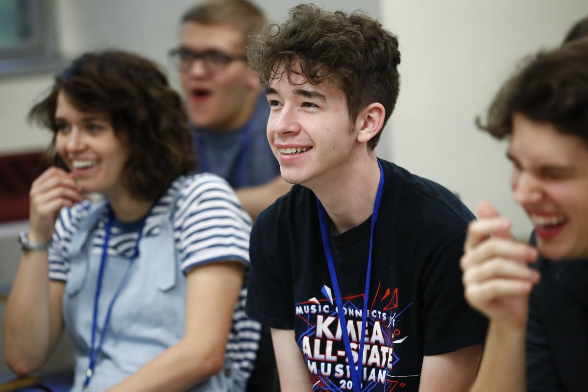 Kaylee-Jo Wilkerson, 17, of Bremen, left, and James Pinkley, 17, of Harlan, center, laugh Friday during the Cracks, Boos and Whistles class during the Governor’s School for the Arts at the University of Kentucky College of Fine Arts. The class gives students a chance to hear recordings of mistakes made in famous performances throughout history.