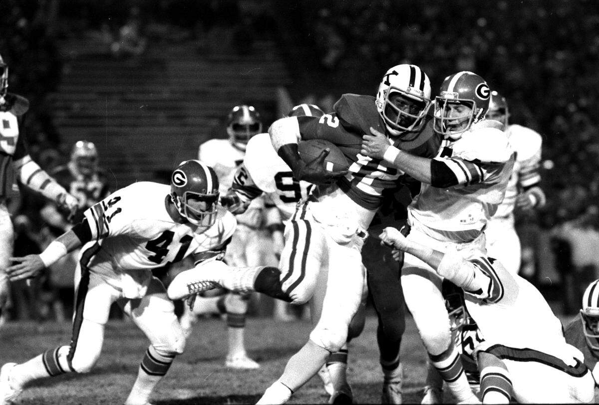 Known for his running prowess, Kentucky quarterback Derrick Ramsey (12) crossed up Georgia by throwing for three touchdowns in UK’s 33-0 shutout victory over the home-standing Bulldogs in 1977.