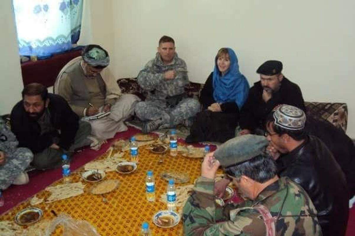 Former diplomat Deborah Alexander at a shura, or a meeting of village elders in Afghanistan. She went to this village to ask permission to start a midwife training program.