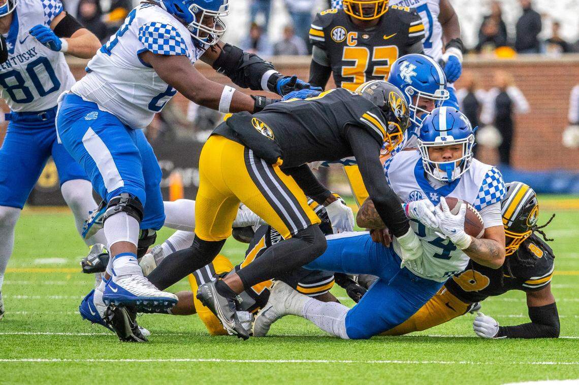 Kentucky running back Chris Rodriguez (24) is tackled by Missouri defensive back Jaylon Carlies (1) and linebacker Ty’Ron Hopper (8) on Saturday. Rodriguez had 29 carries for 112 yards in the Cats’ victory.