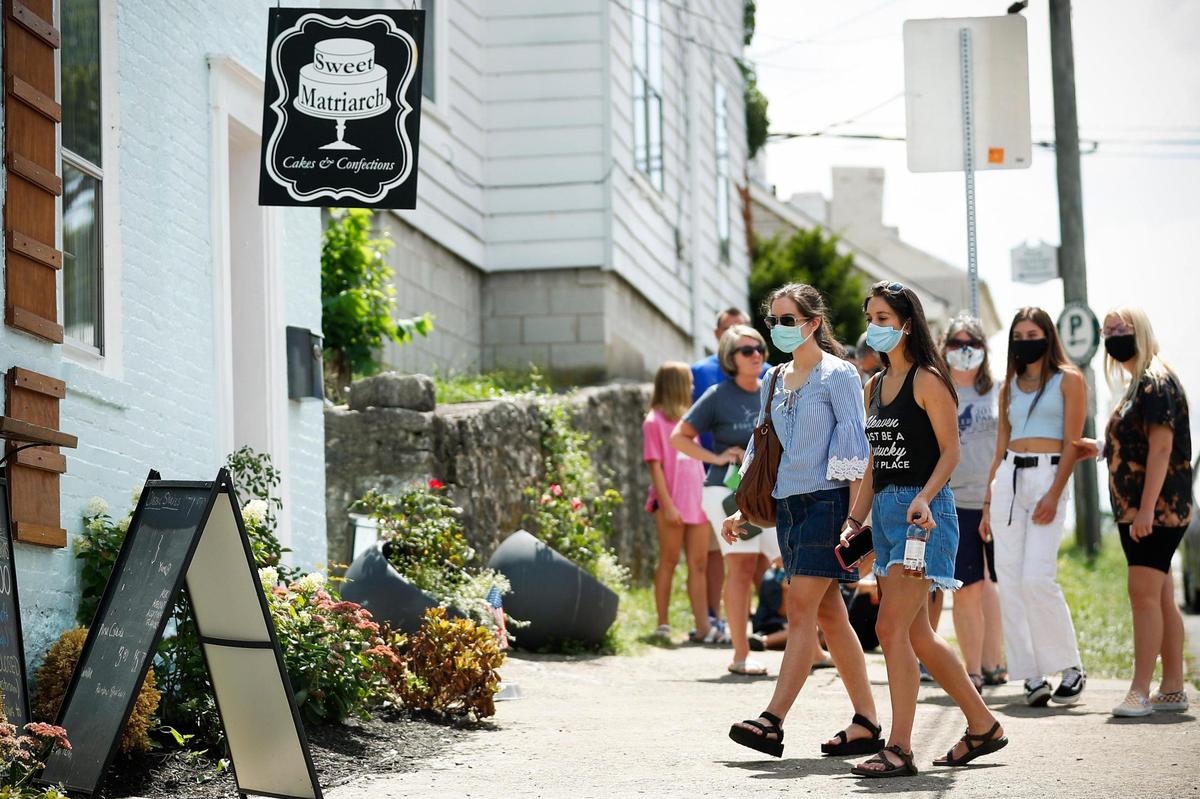 Catherine Heredia, of Lexington, left, and Sophia Heredia, of Dayton, Ky., approach the window Aug. 15 to order milkshakes at Sweet Matriarch Bakery in Georgetown. People usually begin lining up before the shop opens for the day.