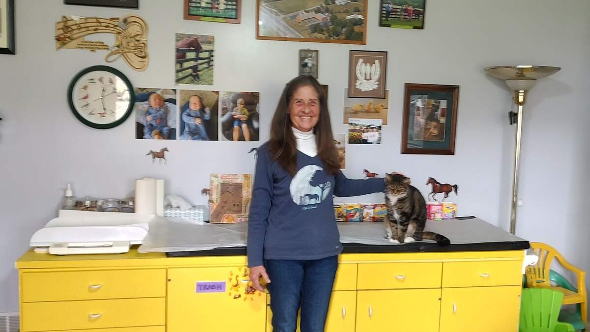 Dr. Rebecca Bosomworth was photographed with her cat Dennis in her office at her home in Lexington.