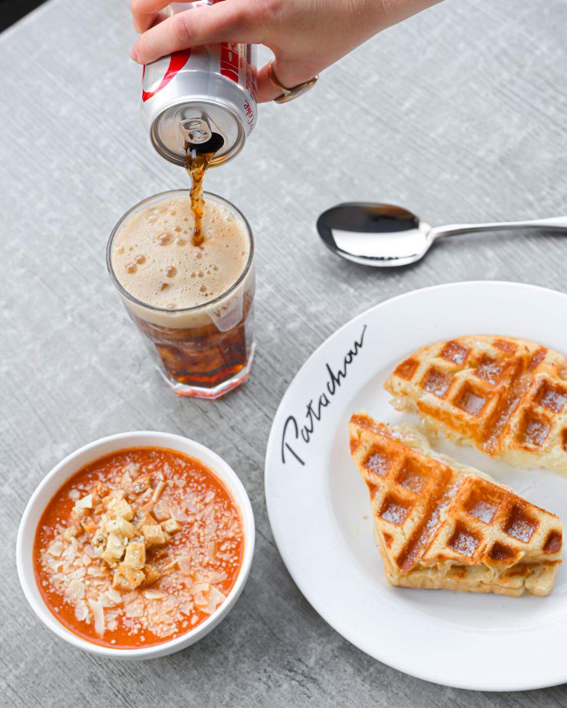 Cafe Patachou is a breakfast and lunch restaurant from Indiana. The menu includes sandwiches such as the Waffled Grilled Cheese, made with Cheddar and Swiss on “waffled” sourdough with a Parmesan crust, served with a cup of tomato artichoke soup.