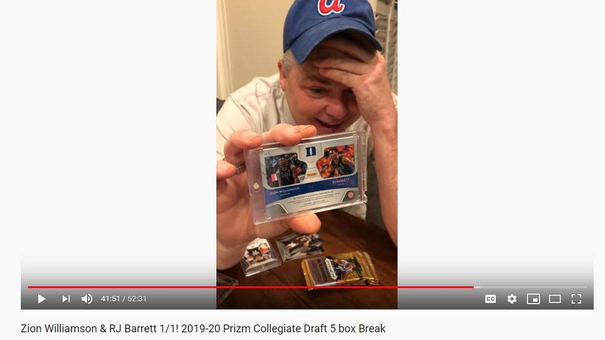 Jimmy Mahan shows off an autographed rookie card of R.J. Barrett and Zion Williamson, the only one of its kind. He donated the proceeds to a North Carolina children’s home.