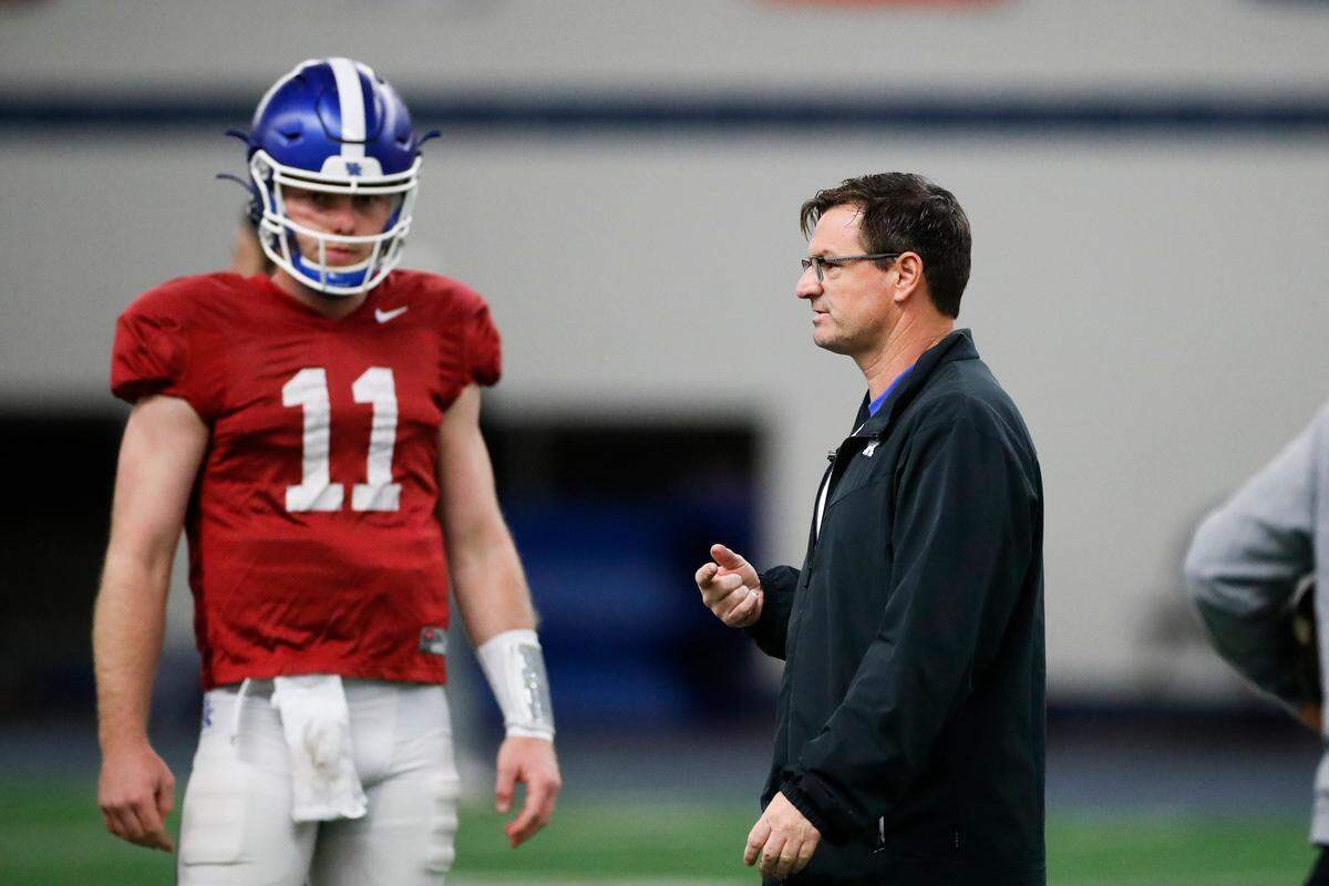 Kentucky offensive coordinator Rich Scangarello spoke with Wildcats backup quarterback Beau Allen during an open practice last month.