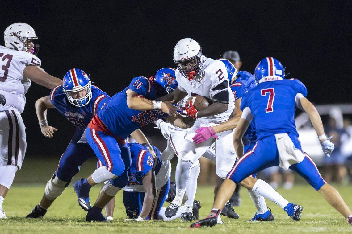 Tates Creek's Bryan Evans Jr. (2) runs the ball past Mercer County defenders during the Fort Harrod Bowl at Alvis Johnson Field in Harrodsburg on Aug. 23.