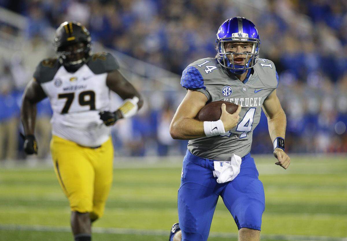 Former Kentucky quarterback Patrick Towles (14) ran for this second quarter touchdown and threw two TD passes in the second half to lead UK to a 21-13 upset of No. 25 Missouri in 2015. It was the first victory over a ranked team for Mark Stoops as Kentucky coach.