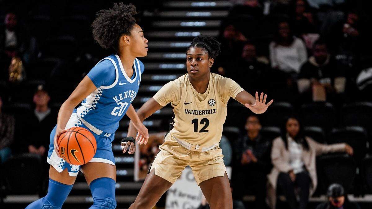 Kentucky’s Amiya Jenkins (20) is guarded by Vanderbilt’s Demi Washington on Sunday in Nashville. She had seven points and eight rebounds in the Wildcats’ loss.