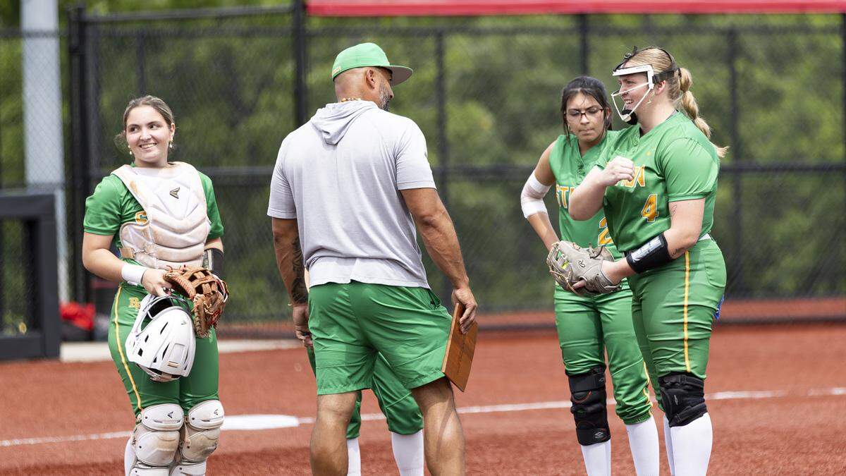 Bryan Station’s Karsyn Rockvoan, right, talks with Coach Hector Urbaneja during a first inning timeout with teammates, from left, Olivia Greenberg, Bekah Clark and Adrienn Arcure listening in during the 11th Region Softball Tournament championship game at George Rogers Clark High School in Winchester on Saturday.