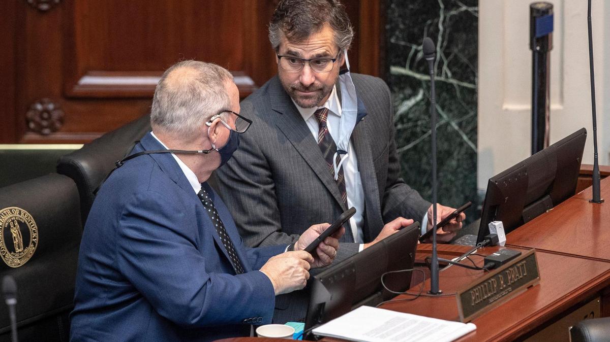 Kentucky state Rep. Chad McCoy, right, R-Bardstown, speaks to Rep. Phillip Pratt, R-Georgetown, in the House chambers at the Kentucky state Capitol in Frankfort, Ky., on Friday, March 12, 2021.