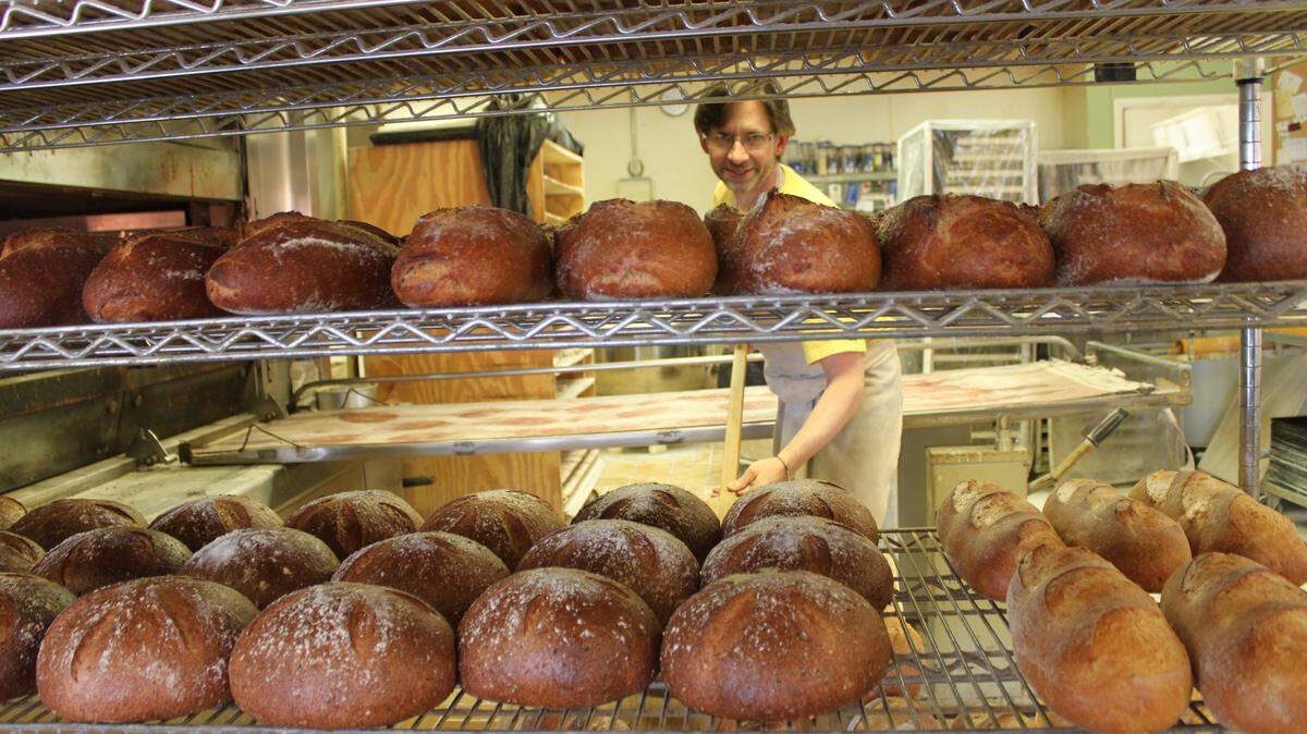 Jim Betts with some of his artisan loaves in 2011 when the bakery was celebrating its 20th anniversary. In college, he says, "I fell in love with breadmaking." Now he and wife, Francine, are retiring after 35 years and handing the bakery to new owners who will be announced soon.   