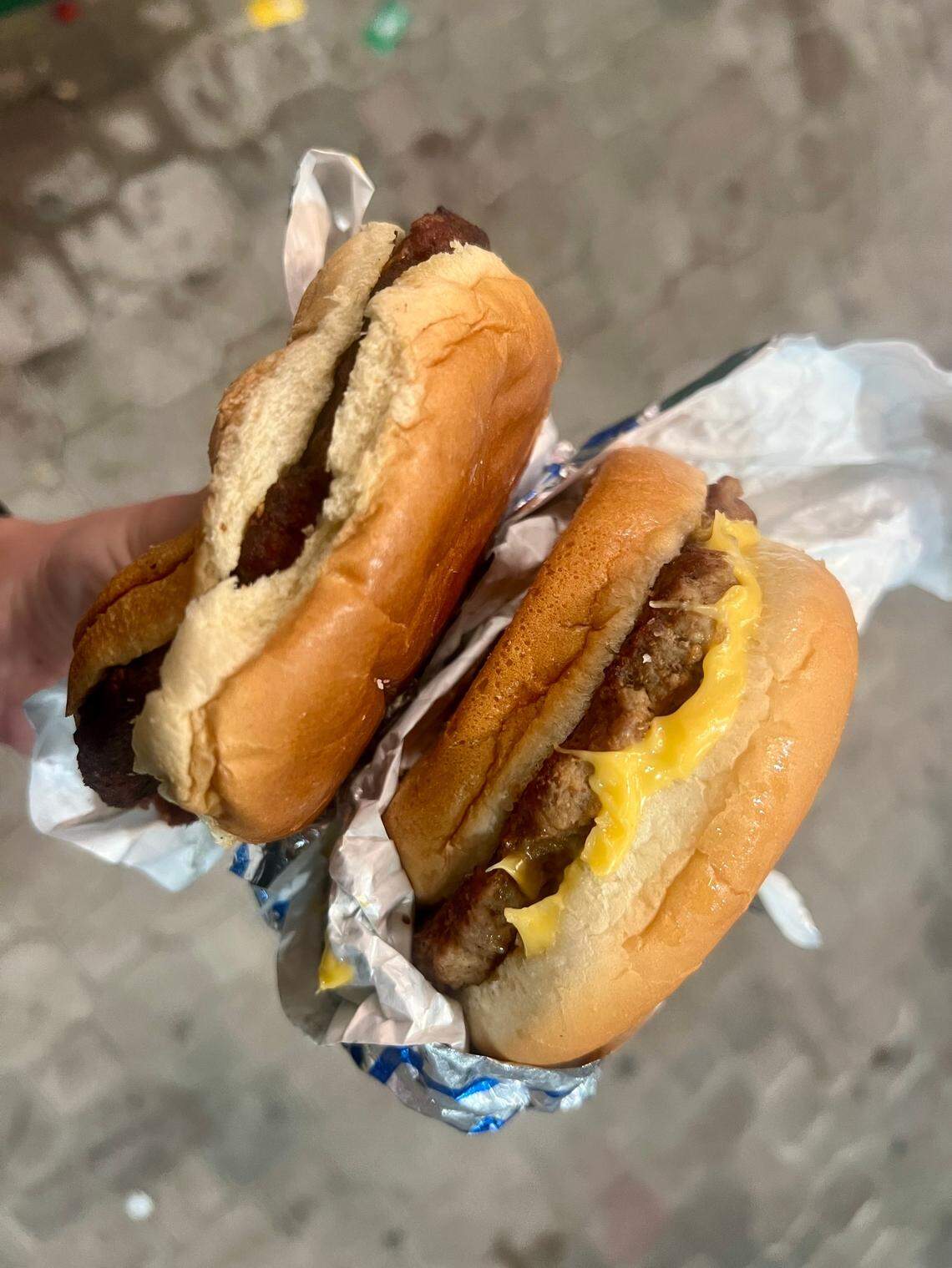 The black bean veggie burger (left) and the cheeseburger (right) are each available at the Paddock Grill during Derby Day.